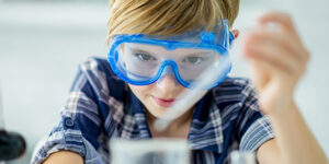 Boy wearing safety glasses using a dropper