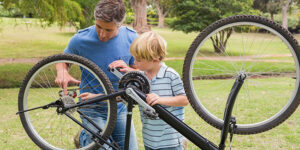 Father and his son fixing a bike