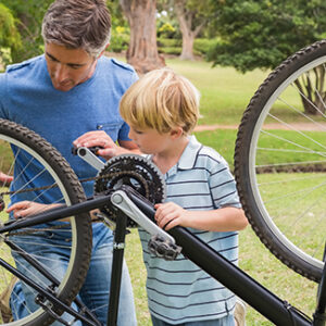 Father and his son fixing a bike