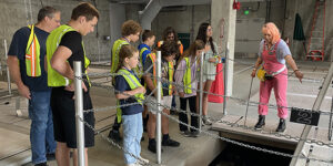 Group of children and adults on a wastewater treatment plant tour.