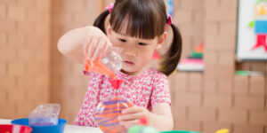 Young girl making sand art