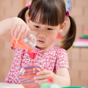 Young girl making sand art