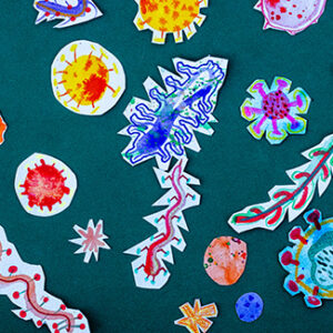 Collage of children's drawings of colorful microbes