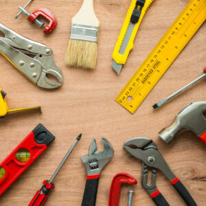 Construction tools laid out in a circle on a work table top