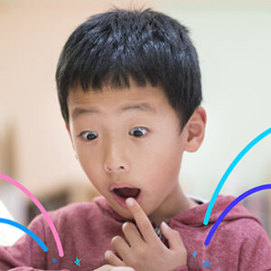 Boy reading with look of amazement
