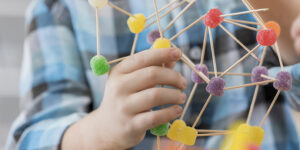 Boy creates something from toothpicks and gum drop candy